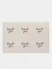 Круглая белая наклейка с надписью "Thank You"