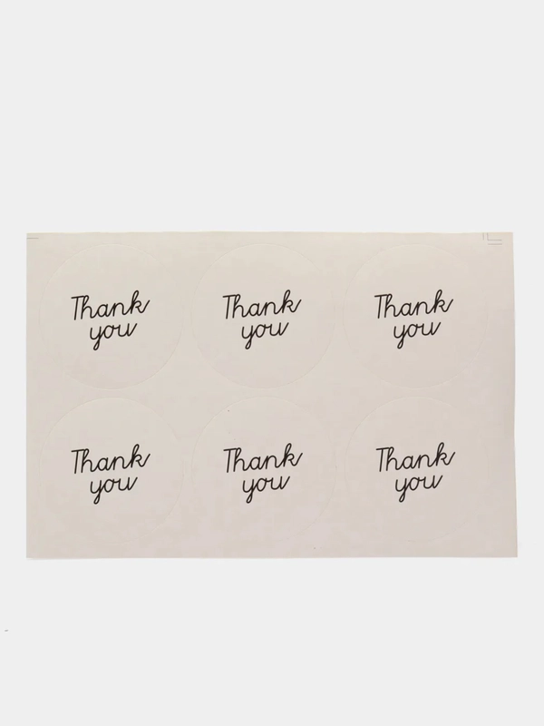 Круглая белая наклейка с надписью "Thank You"