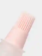 Розовый кисточка для масла с крышкой.
